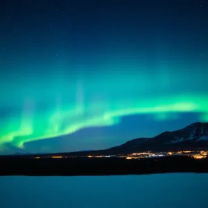 Northern Lights glowing in the night sky over a snowy landscape